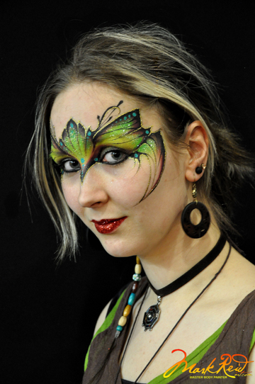woman with a green and black face painting